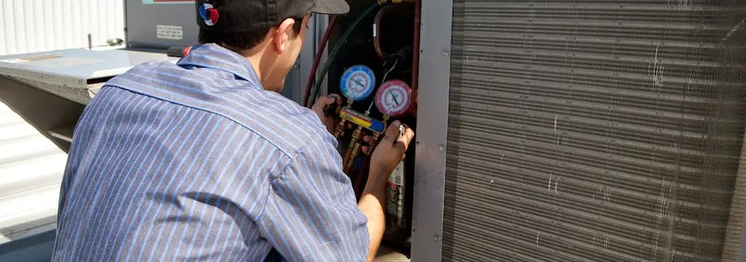HVAC technician servicing a condenser unit in Union